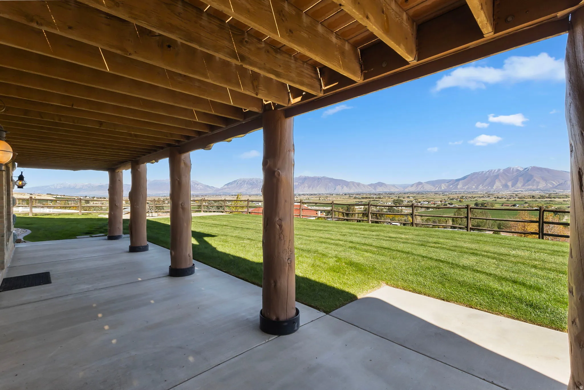 Basement walk out to a covered patio featuring valley and mountain views.