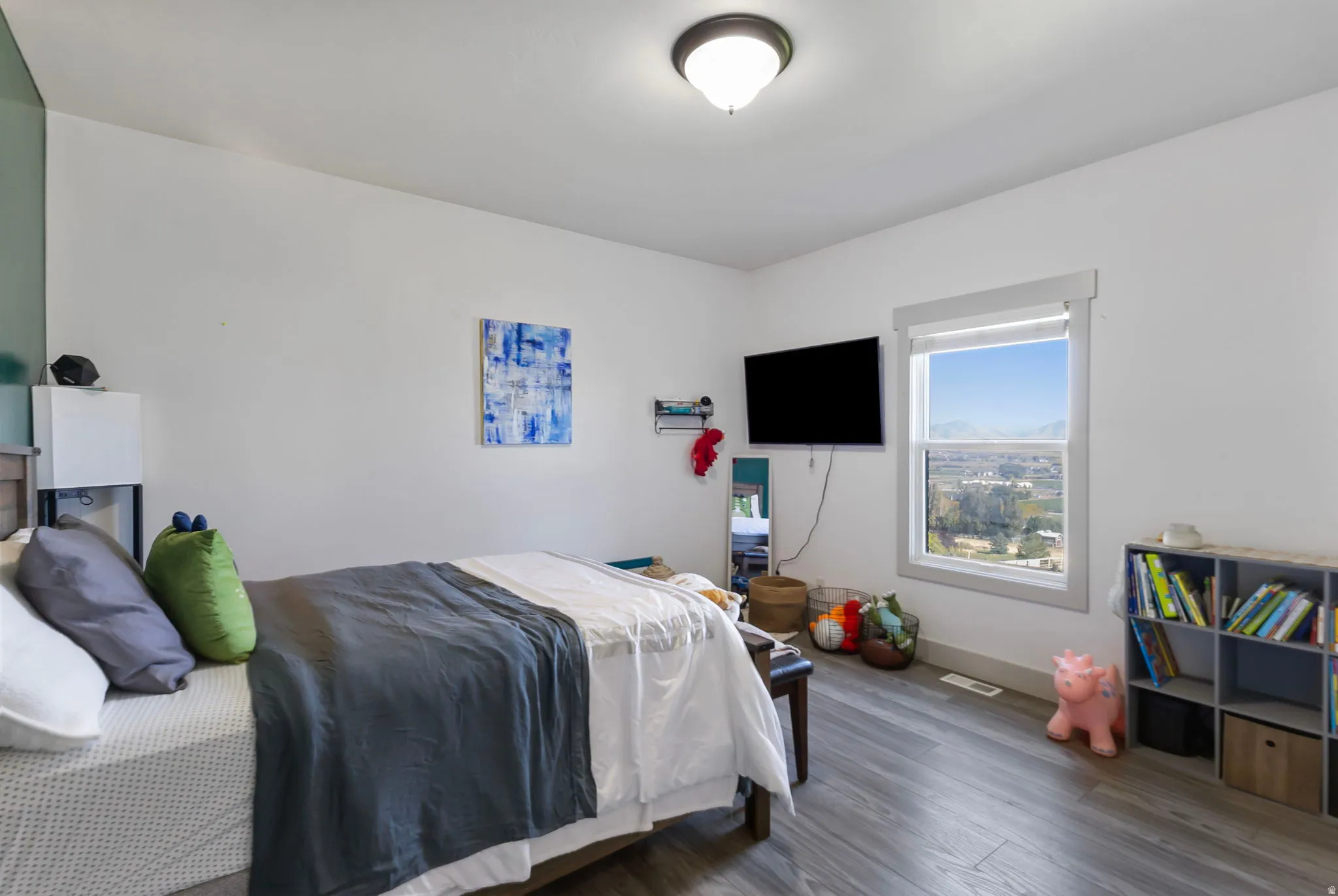 Bedroom with valley and mountain views form window.