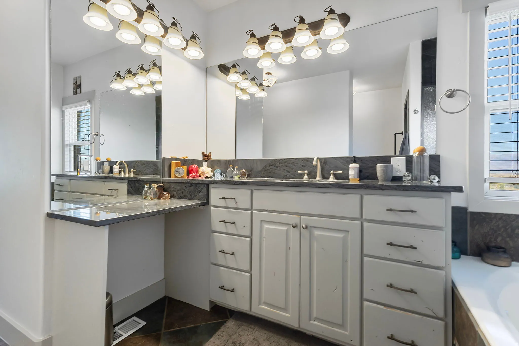Quartzite countertop vanity with built in makeup vanity.