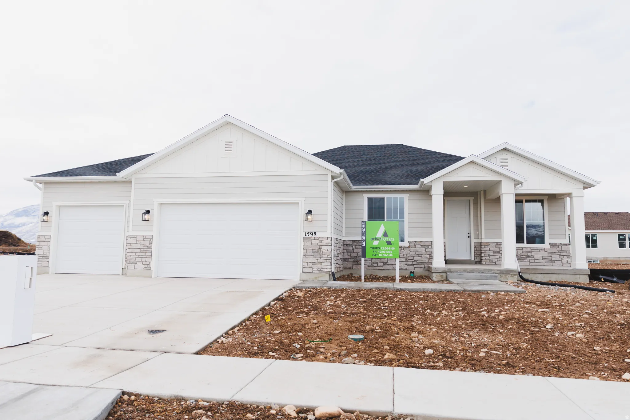 Craftsman inspired home with stone siding, board and batten siding, a garage, concrete driveway, and a shingled roof