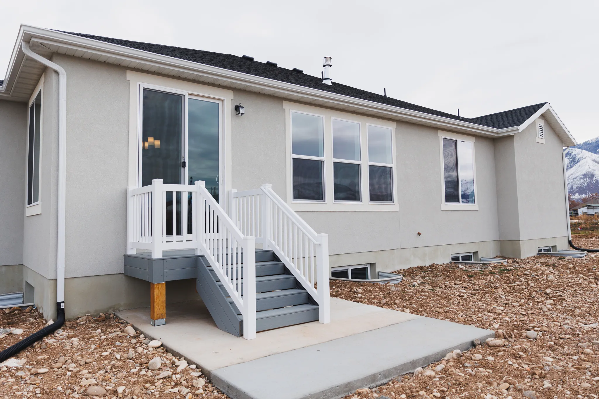 Rear view of house featuring stucco siding