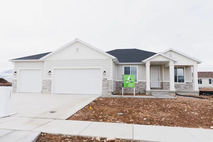 Craftsman inspired home with stone siding, board and batten siding, a garage, concrete driveway, and a shingled roof