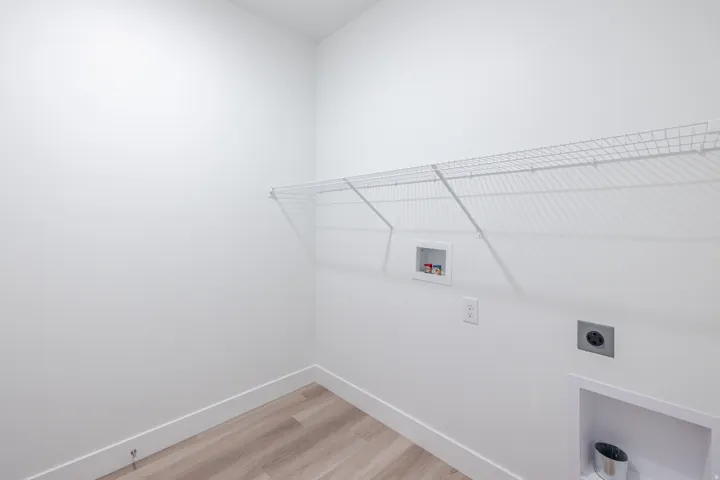 Laundry room with light wood finished floors, hookup for a washing machine, and electric dryer hookup