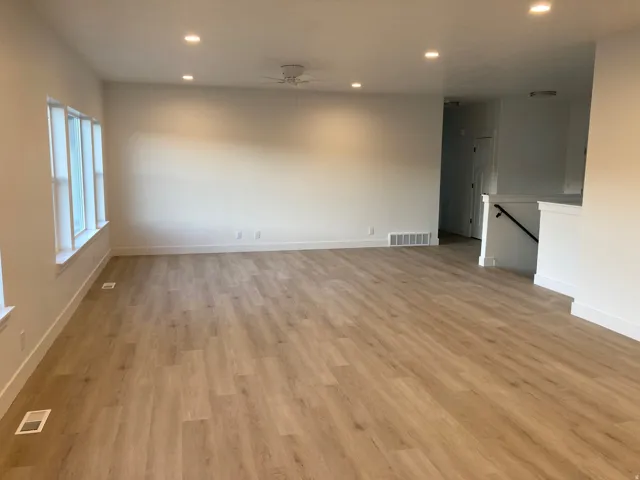 Living room featuring recessed lighting, a ceiling fan, and light LVP flooring