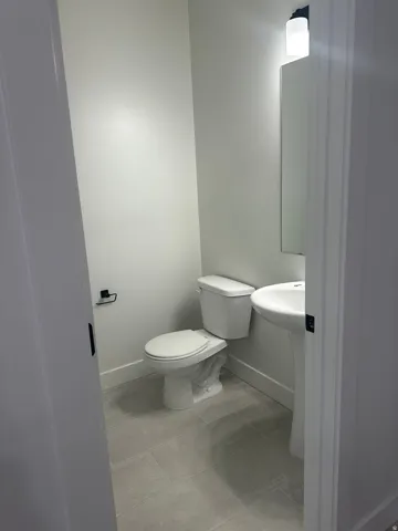 Bathroom featuring baseboards and light tile patterned floors