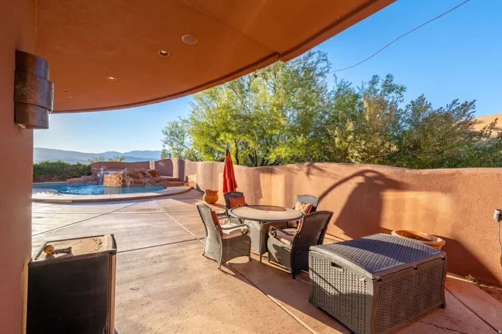 Fenced backyard featuring an outdoor pool, a patio area, a mountain view, and outdoor dining space