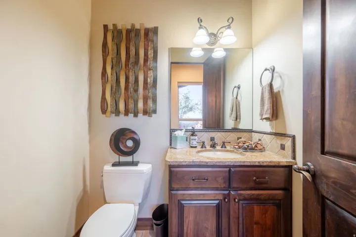 Half bath featuring tasteful backsplash and vanity