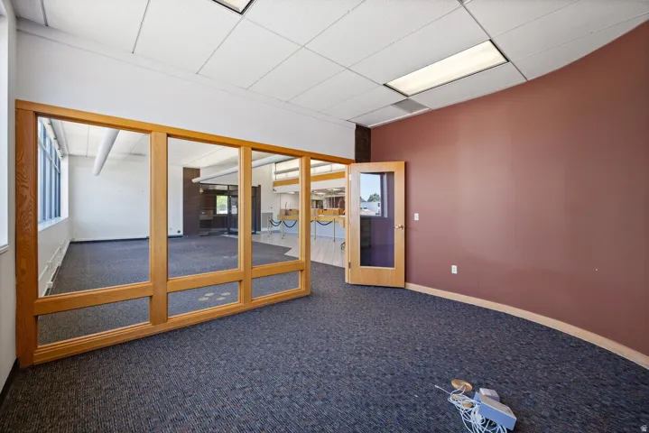 Empty room with carpet and a drop ceiling
