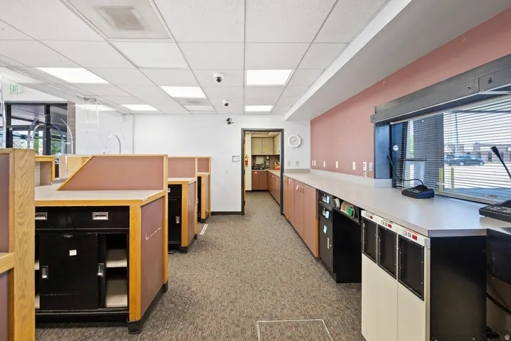 Kitchen with a paneled ceiling and light countertops