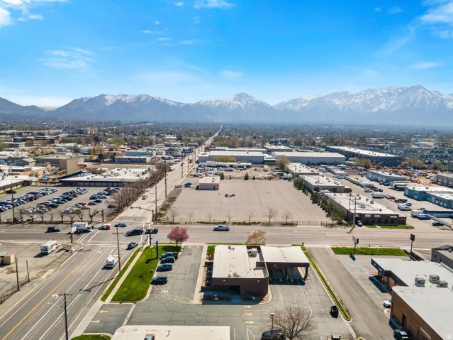 Drone / aerial view of a mountainous background and an industrial area