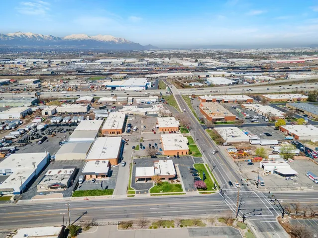 Aerial view of property and surrounding area with a mountainous background