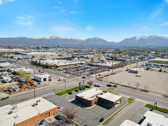 Bird's eye view of industrial structures and a mountainous background