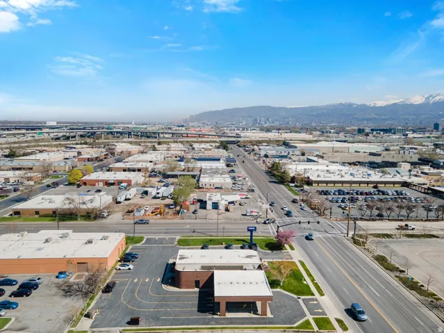Drone / aerial view of a mountain backdrop and industrial structures