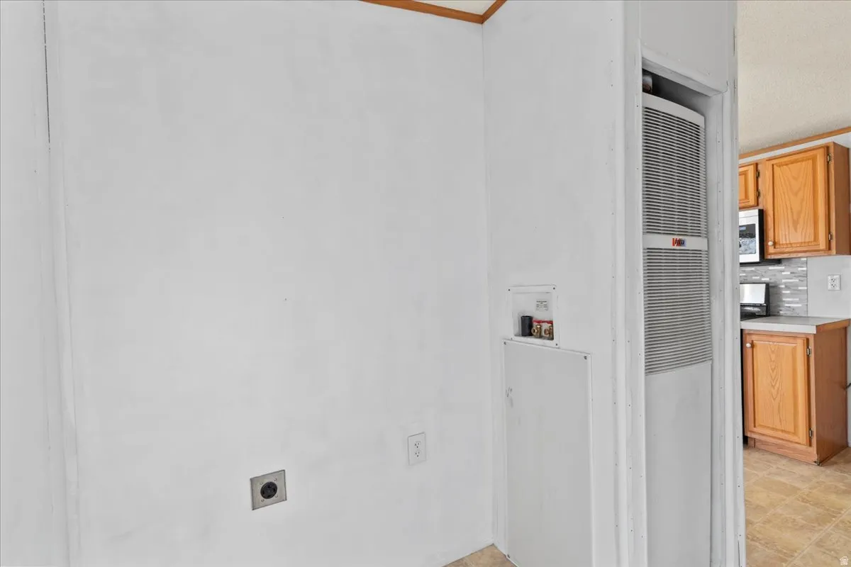 Laundry area with a heating unit, hookup for a washing machine, and electric dryer hookup