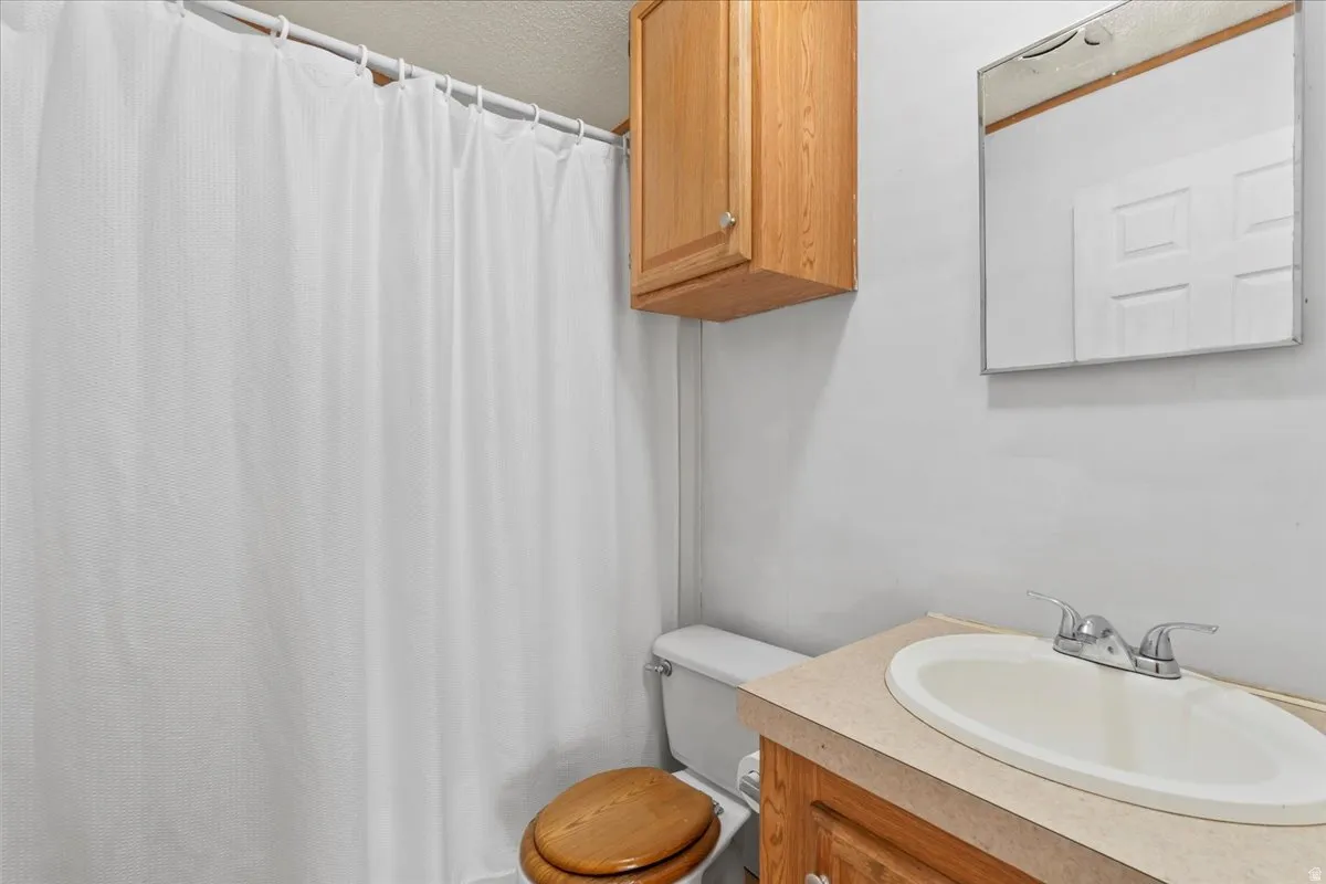 Full bath with vanity and a shower with curtain