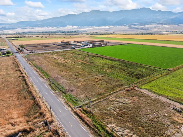 View of rural area with a mountain backdrop and farmland