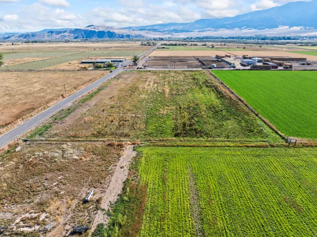 View of rural area featuring mountains and farmland