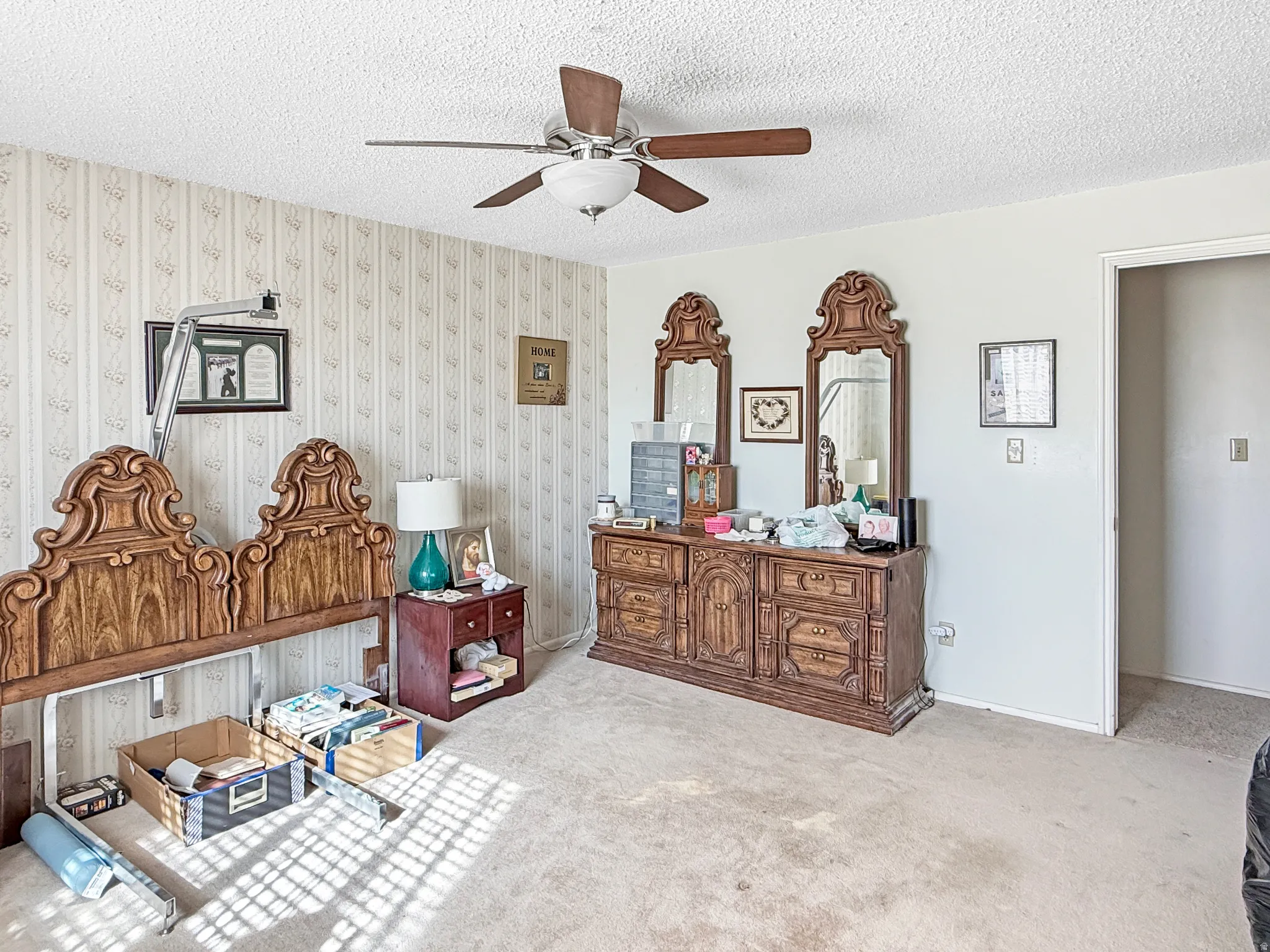 Bedroom featuring a textured ceiling, ceiling fan, and carpet flooring