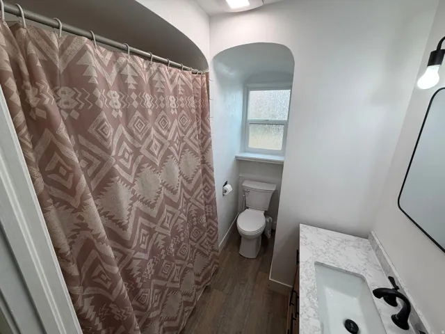 Newly remodeled bathroom with a brand new vanity, toilet and flooring.