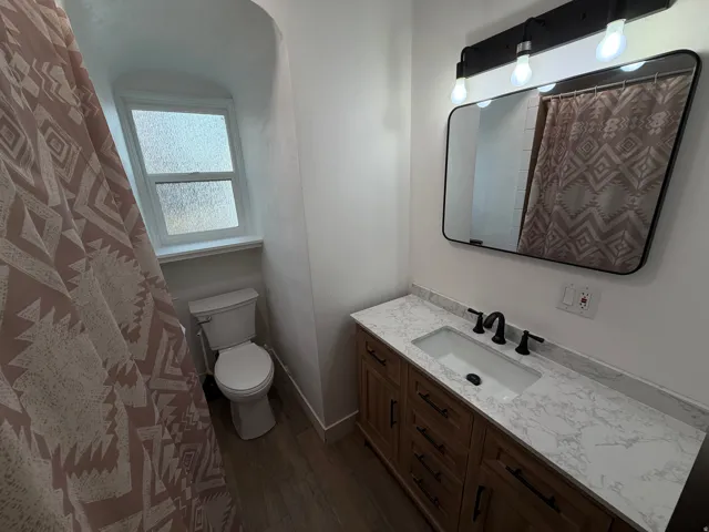 Newly remodeled bathroom with a brand new vanity, toilet and flooring.