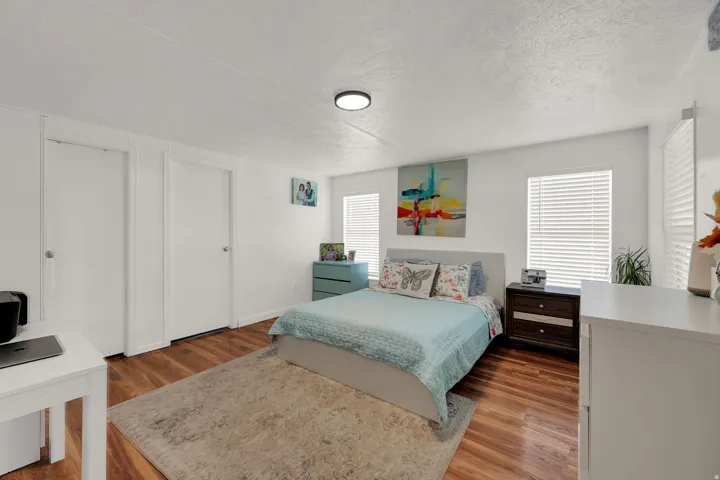 Bedroom with light wood-type flooring and a textured ceiling