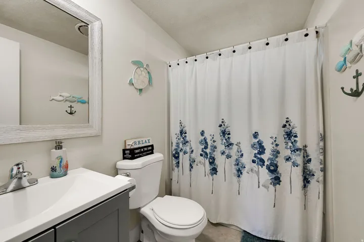 Full bath featuring vanity, a textured ceiling, and a shower with curtain
