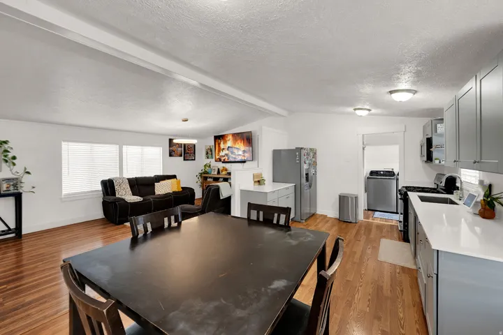 Dining space featuring plenty of natural light, a textured ceiling, light wood finished floors, and washer / dryer