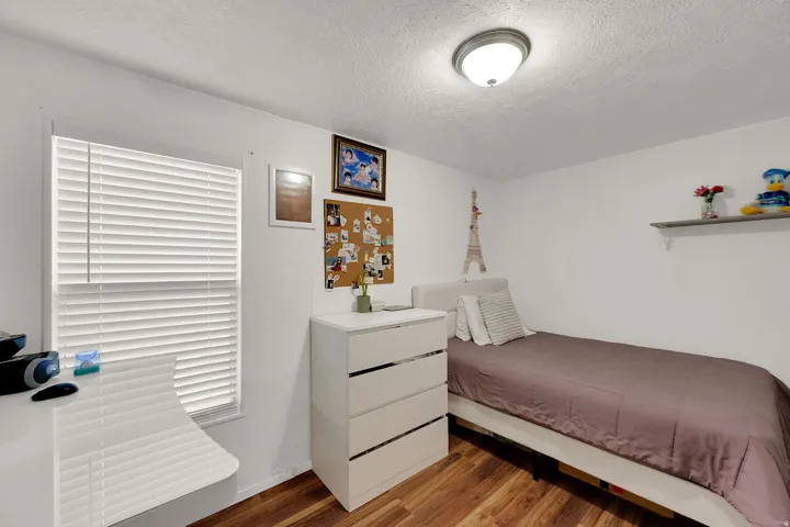 Bedroom with light wood-style flooring and a textured ceiling