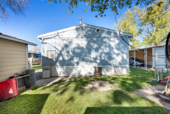Back of property featuring a yard and a patio area
