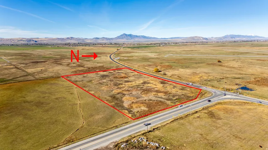Overview of rural landscape with property boundaries highlighted and a mountain backdrop