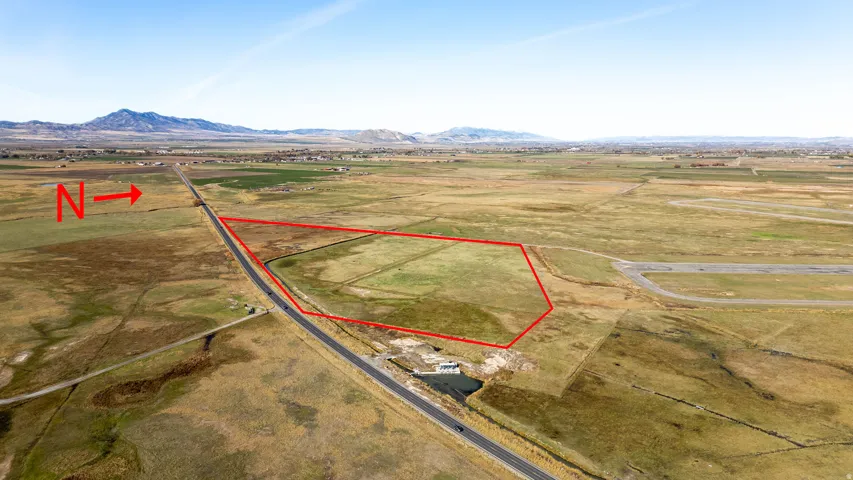 Overview of rural landscape featuring property parcel outlined and a mountain backdrop