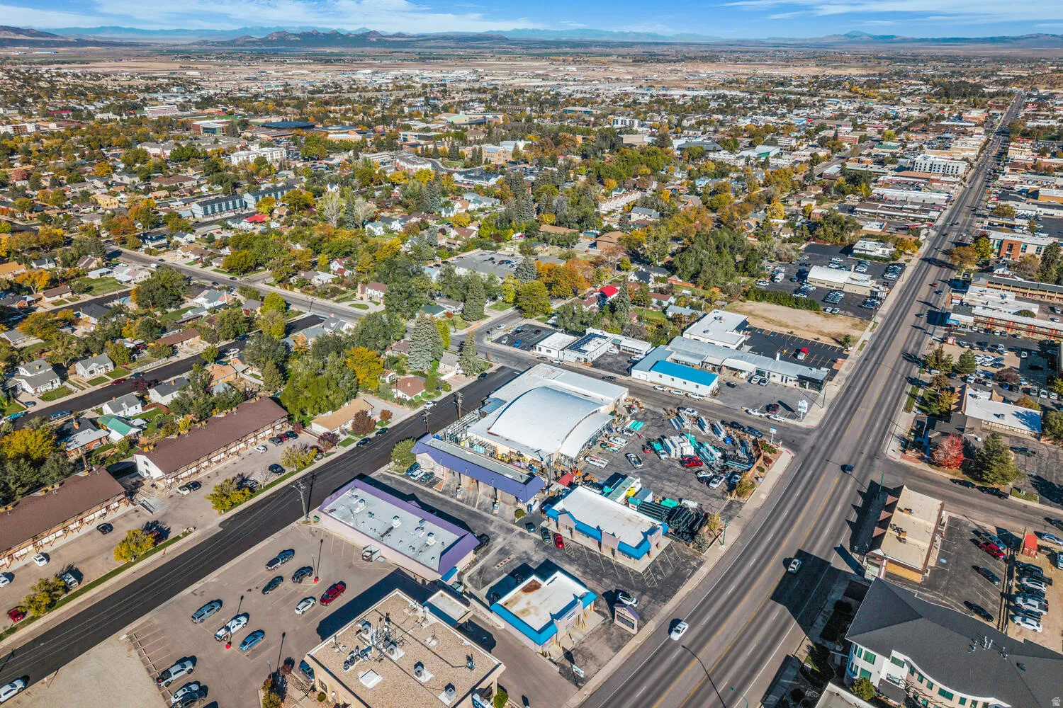 Aerial view of property and surrounding area featuring mountains