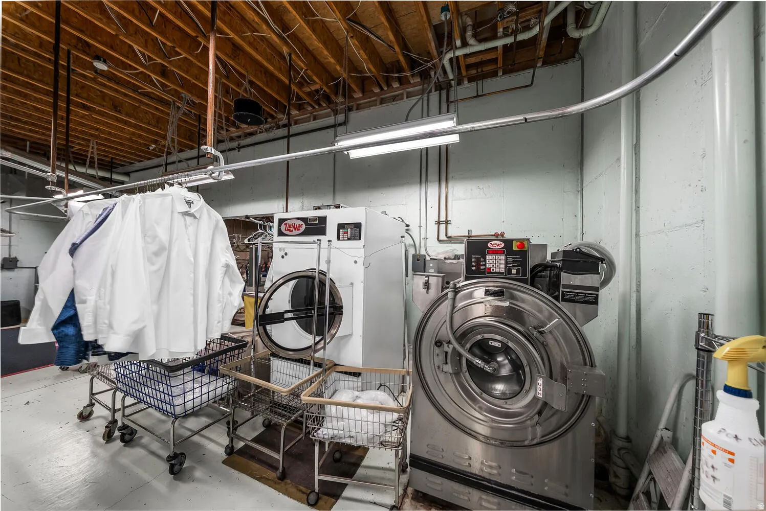Laundry area with concrete floors