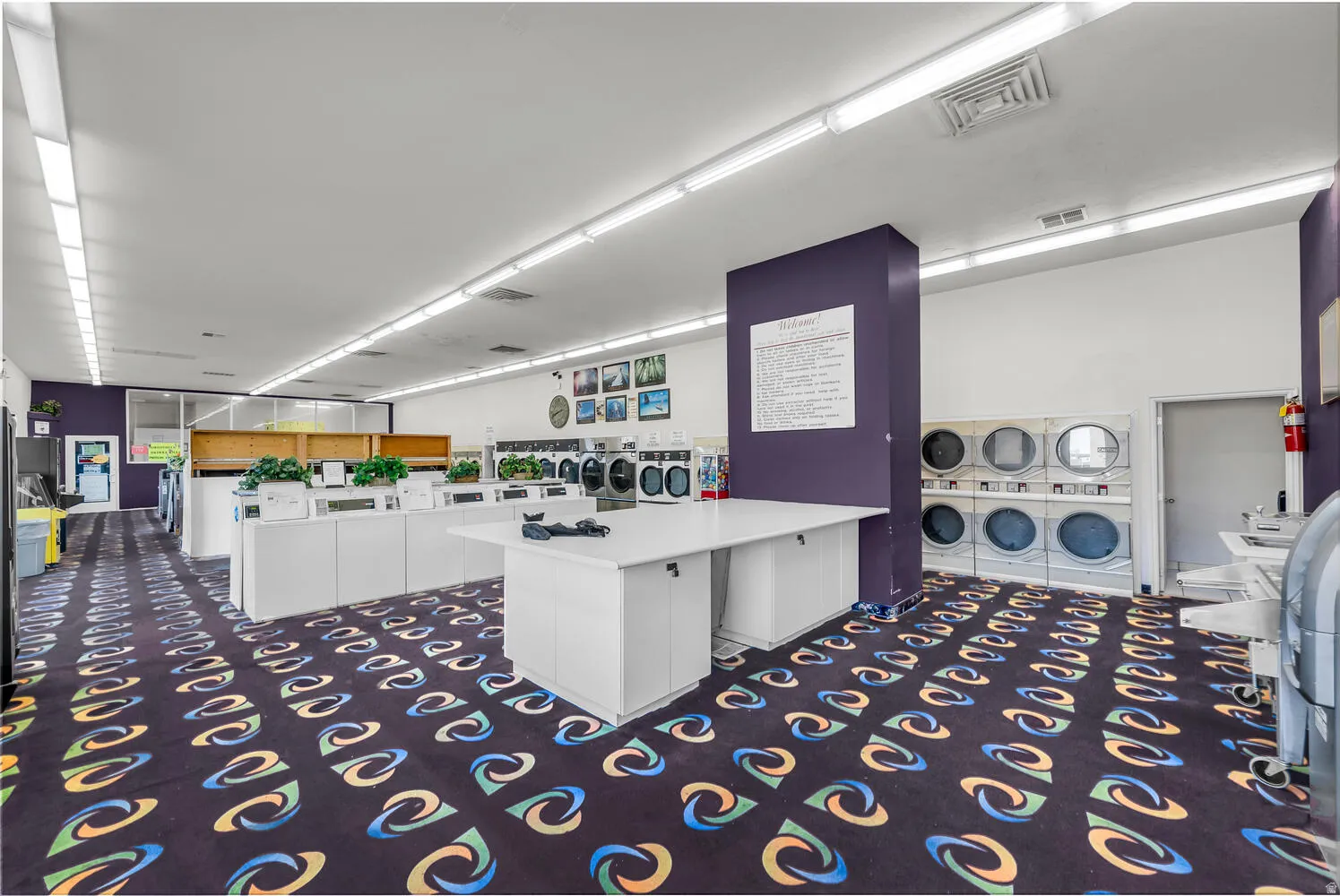 Shared laundry room featuring washing machine and dryer and stacked washer / drying machine