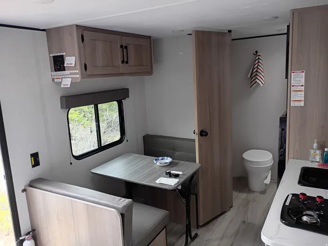 Kitchen with light wood-type flooring, light countertops, and brown cabinets