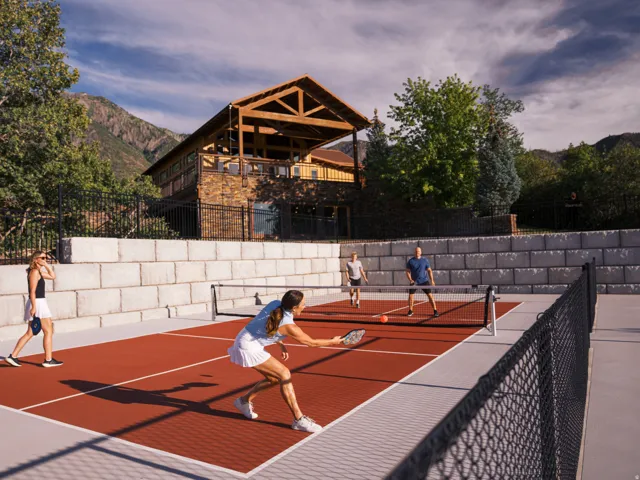 View of tennis court with a deck with mountain view