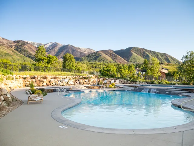 Community pool with a patio area and a mountain view