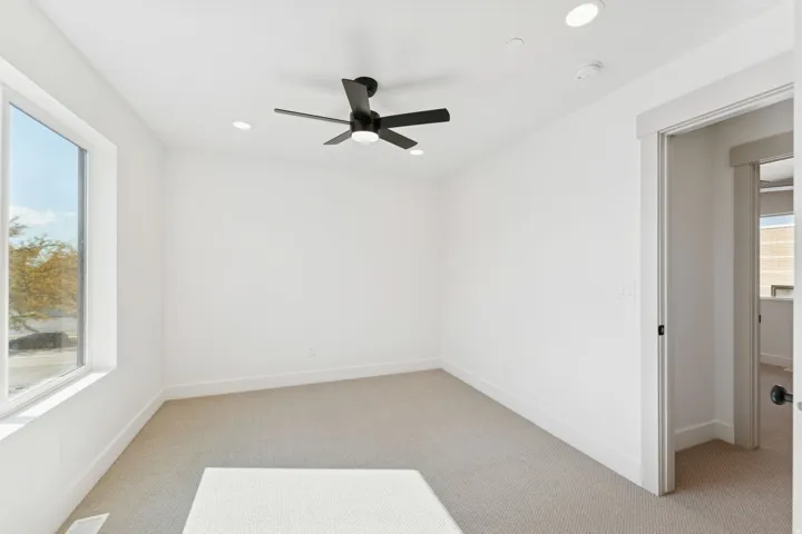 Spare room with light carpet, ceiling fan, and recessed lighting