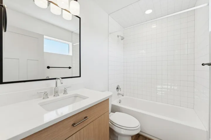 Full bath featuring washtub / shower combination and vanity