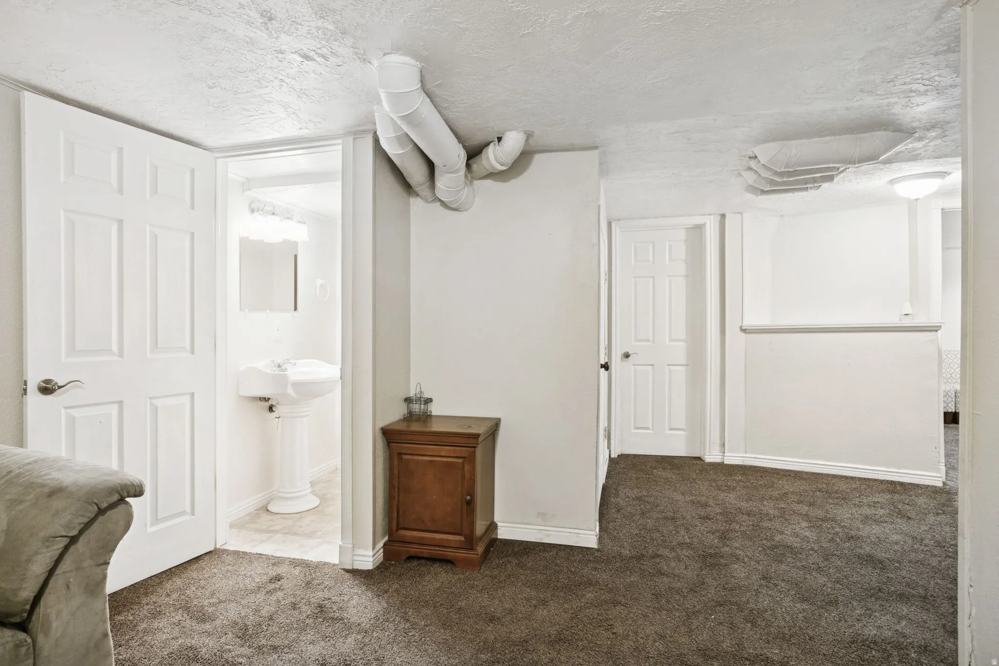 Bathroom featuring carpet floors and a textured ceiling