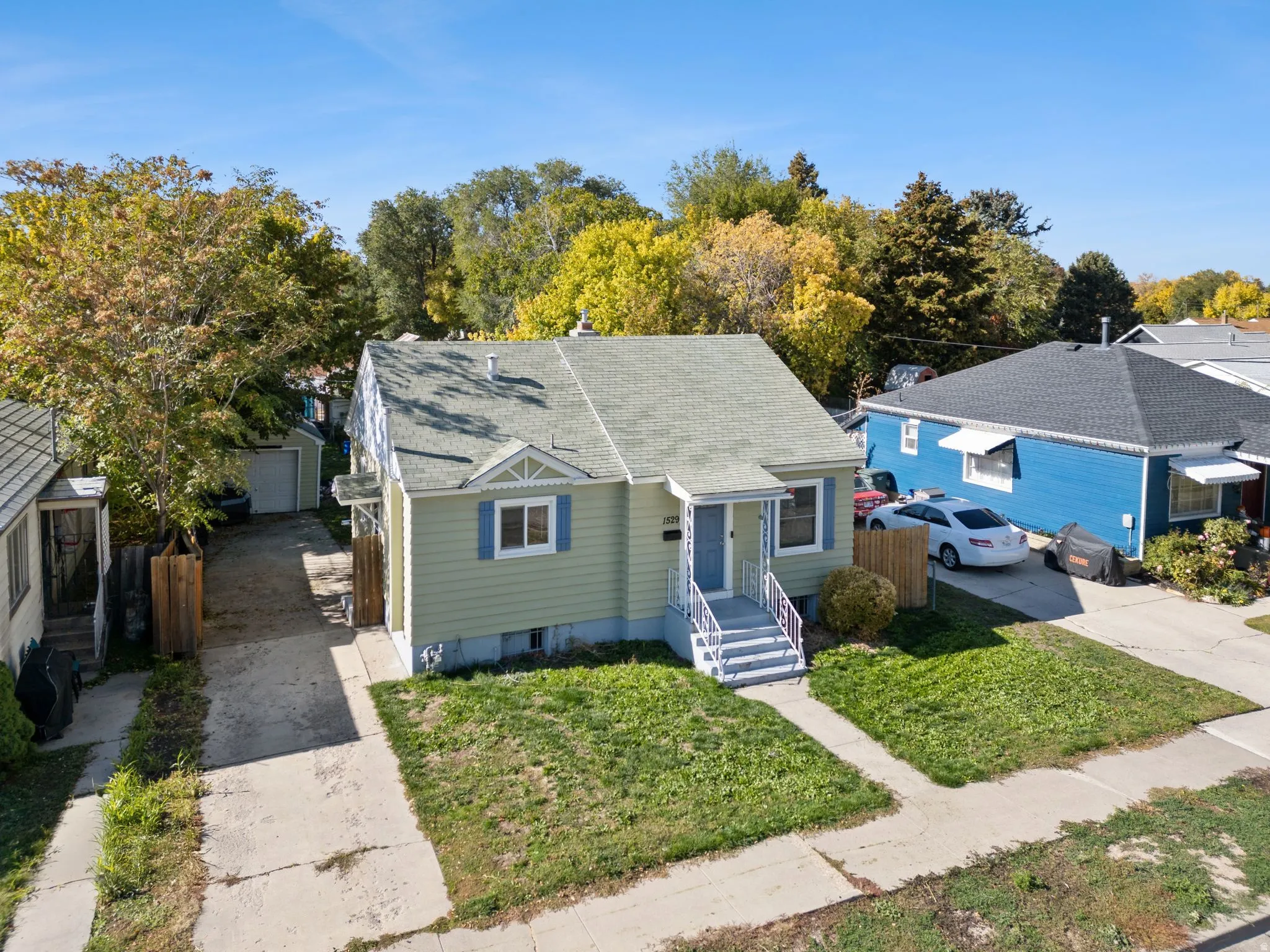 Bungalow-style house featuring a shingled roof and driveway
