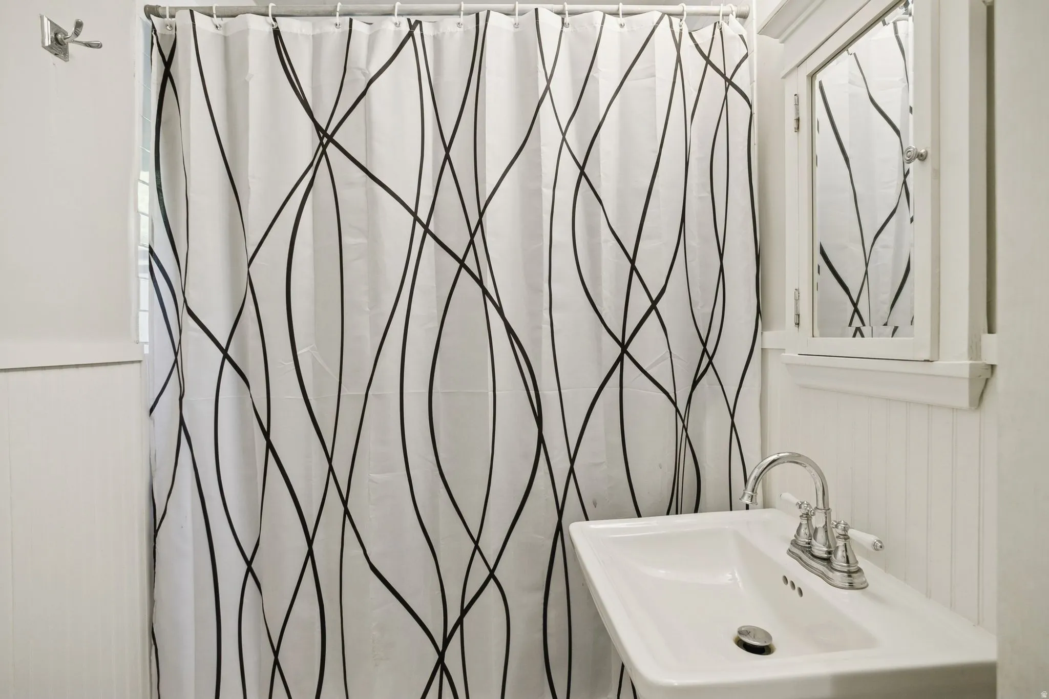 Bathroom featuring a shower with shower curtain