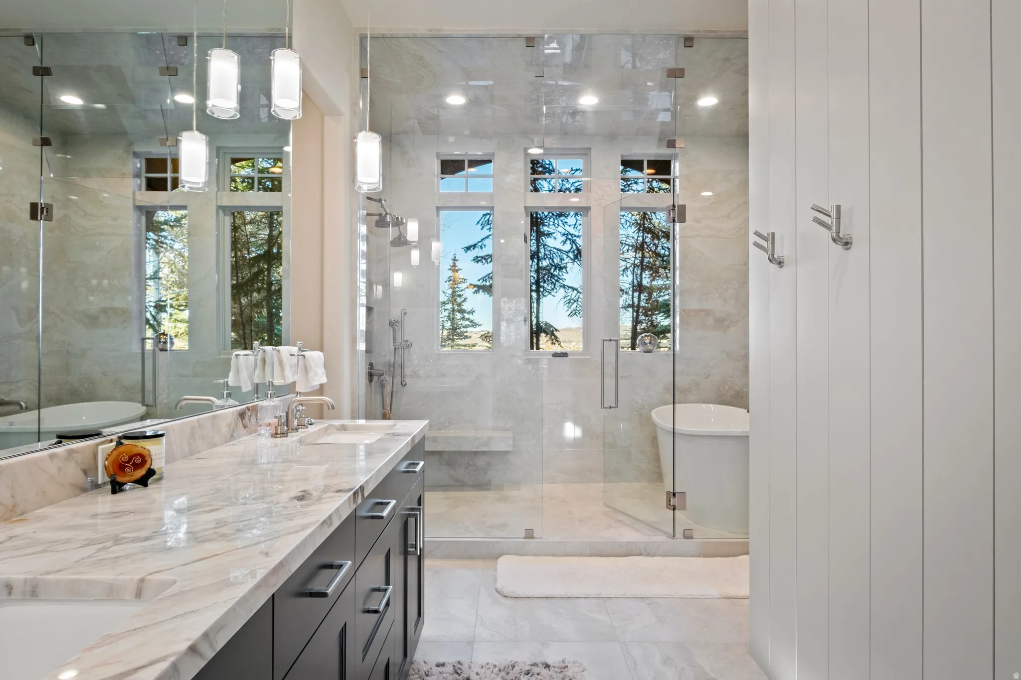 Full bath with a shower stall, a freestanding tub, and double vanity