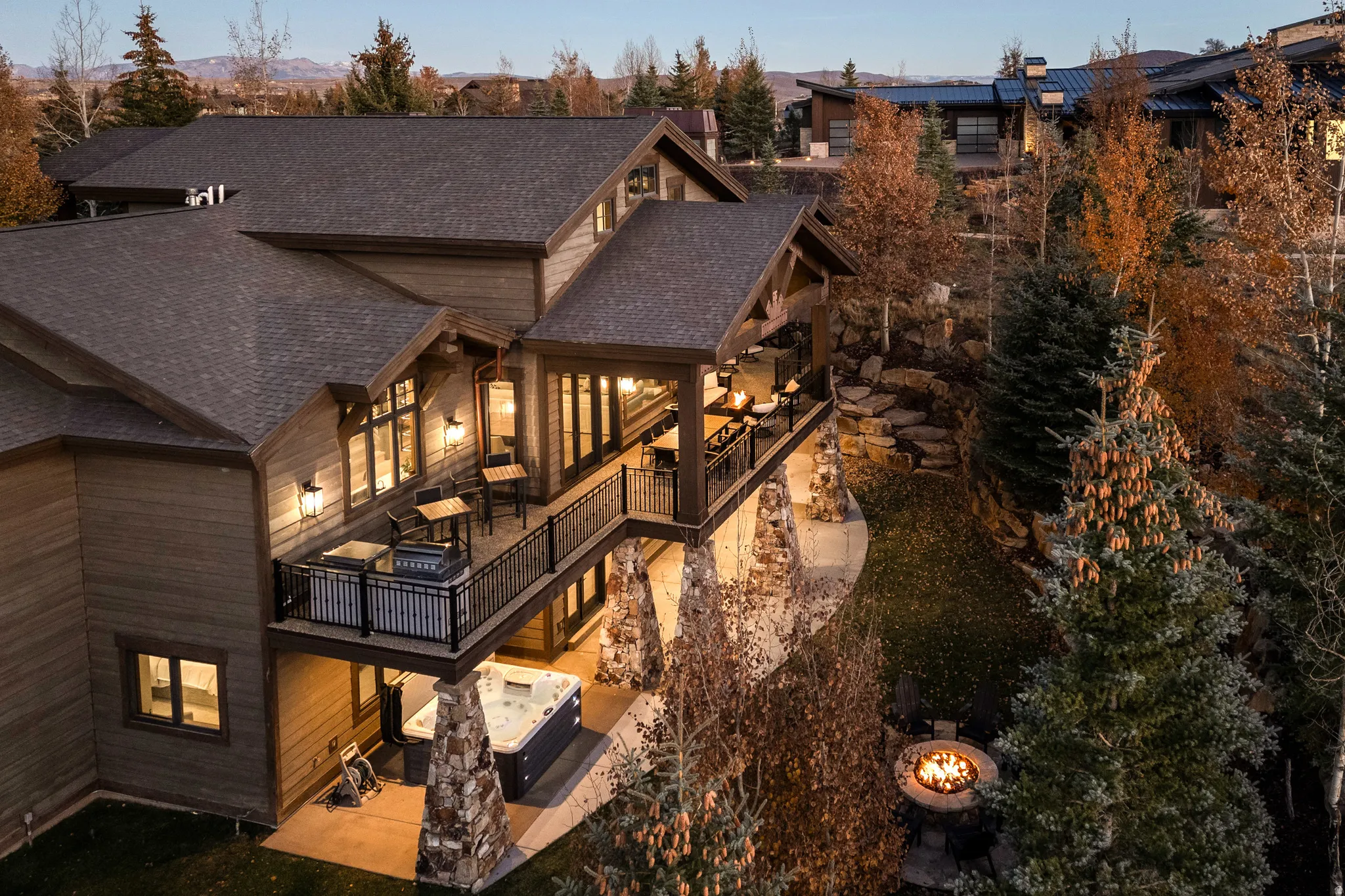 Rear view of house featuring a patio area and roof with shingles