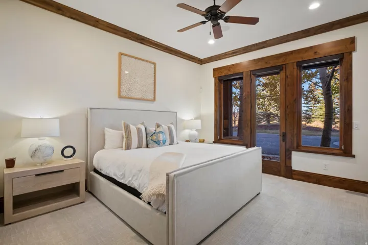 Bedroom with access to exterior, carpet flooring, ceiling fan, and crown molding