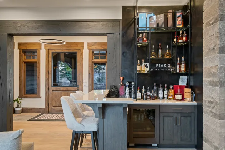 Indoor bar featuring open shelves, wine cooler, and light wood-type flooring