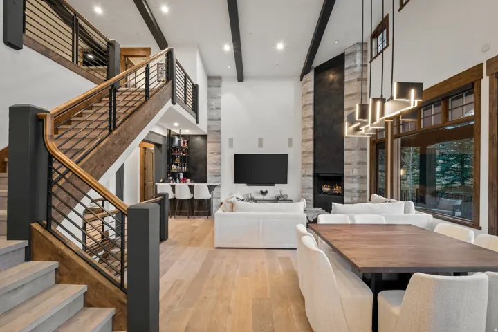 Dining space with light wood finished floors, a fireplace, and recessed lighting