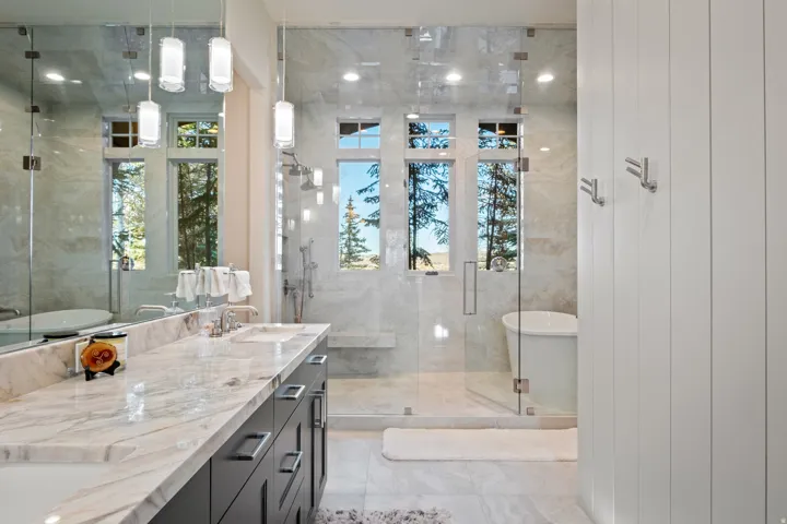 Full bath with a shower stall, a freestanding tub, and double vanity