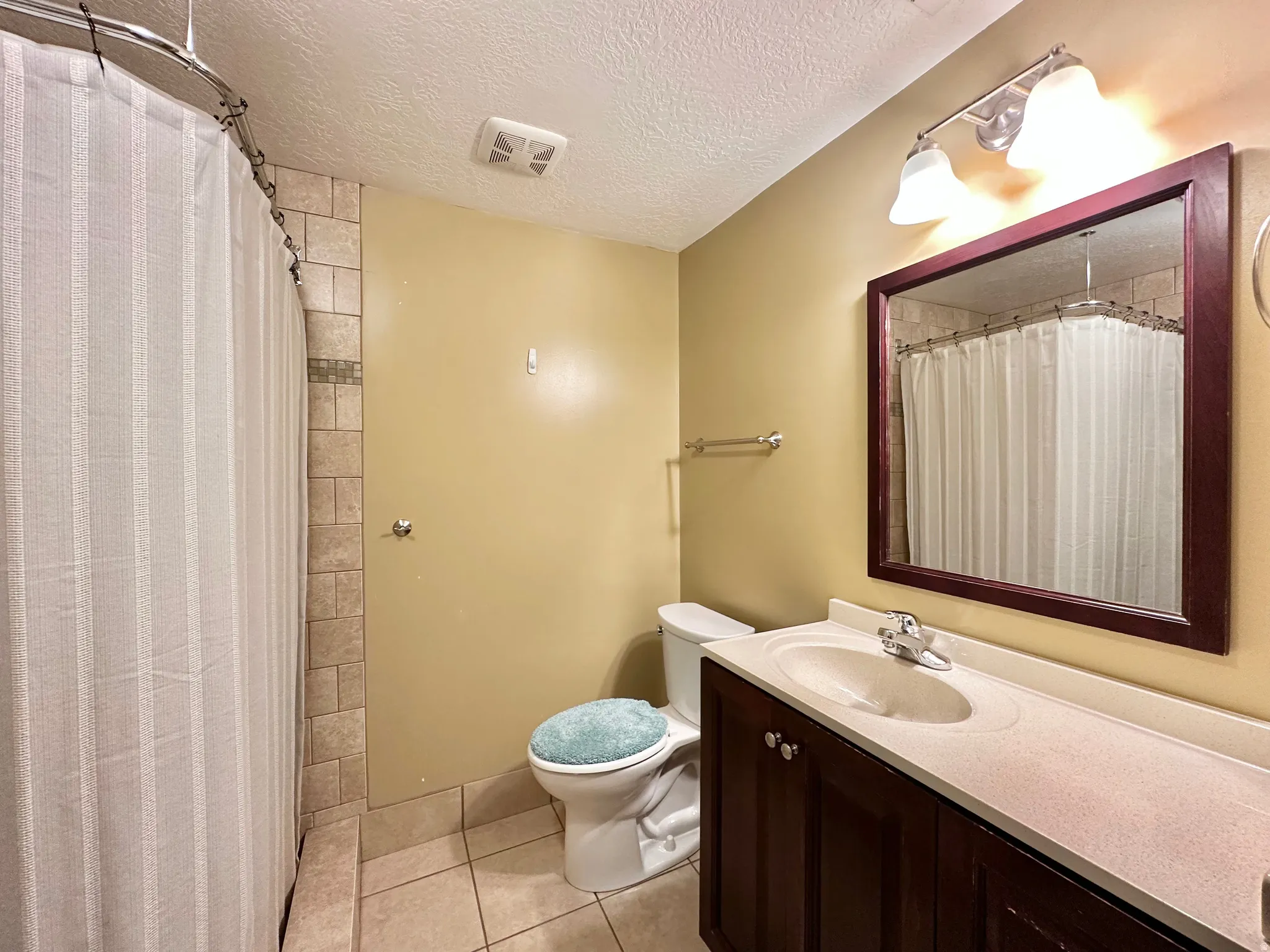 3/4 bathroom in basement and shared space with laundry