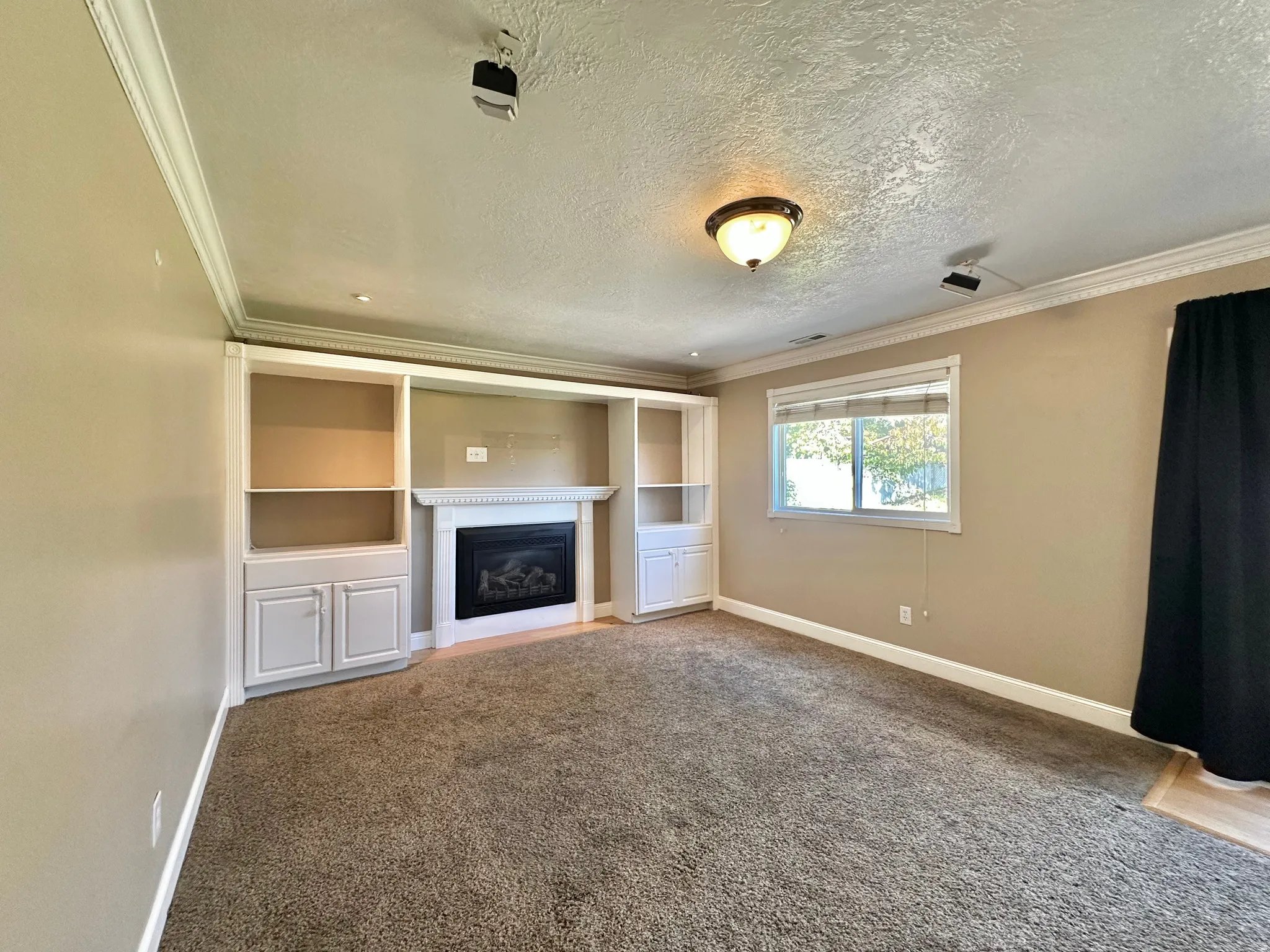 Family room with fireplace and door to backyard on right.  Door to garage on left.  Surround sound.
